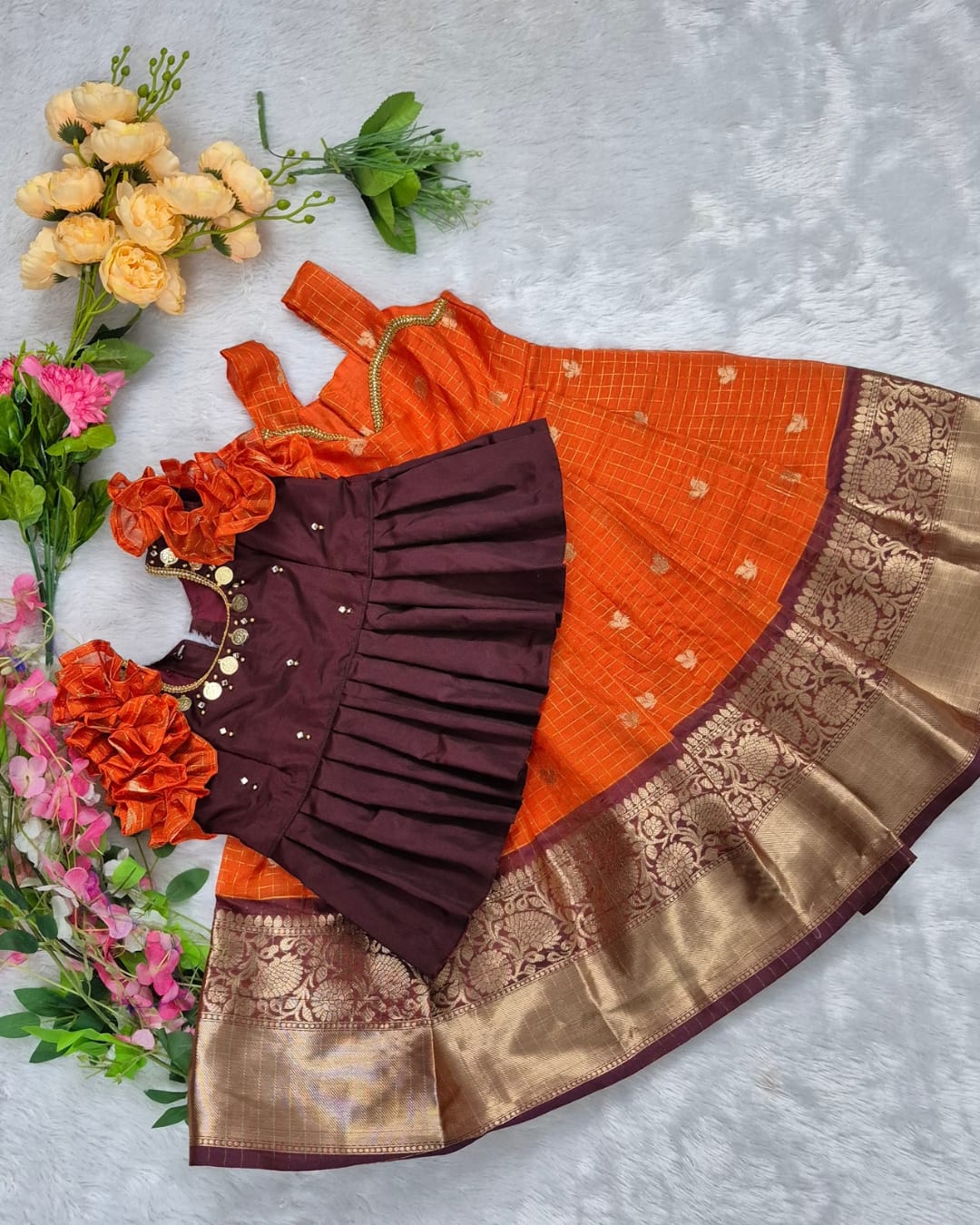 A rich and vibrant Maroon &amp; Orange with Gold zari border combination