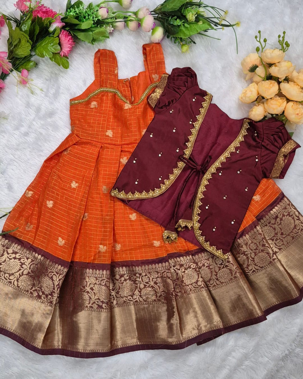 A rich and vibrant Maroon &amp; Orange with Gold zari border combination